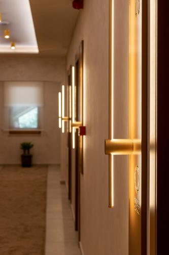 a hallway with a row of lights on the wall at Motel & Restoran Sunce in Busovača