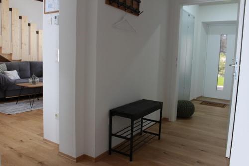 a living room with a black stool in a room at Maisonette im Zentrum Trofaiachs in Trofaiach