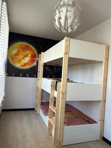 a bunk bed in a room with a astronomy mural at Oostendelle in Ostend