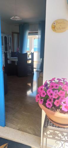 a bowl of flowers sitting on a table in a living room at HAIKU HOME in Cala Gonone
