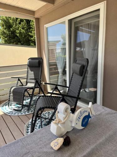 a couple of chairs sitting on a porch at Mobilehome Mali No 2 in Pakoštane
