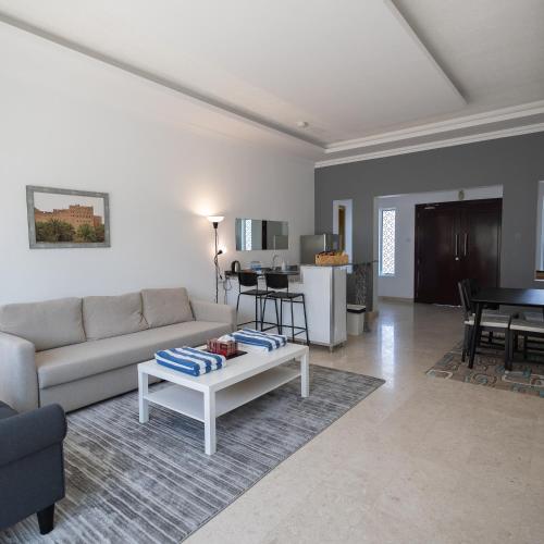 a living room with a couch and a table at THE POOL VILLA - TANUF in Nizwa