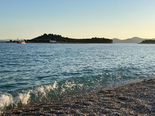 a view of a body of water with a beach at Mobilehome Mali No 2 in Pakoštane