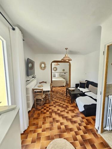 a living room with a couch and a table at Gite Harmonie in Gréoux-les-Bains