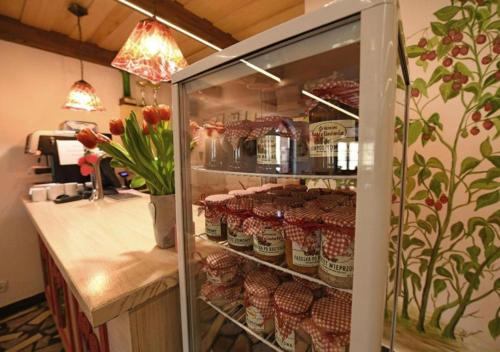 a refrigerator with food in it in a kitchen at Gościniec Malinówka in Krzeszna