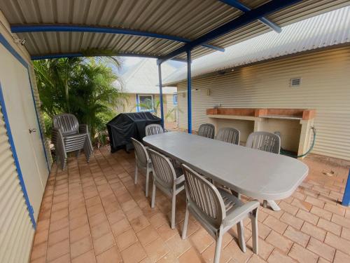 a patio with a table and chairs on a patio at Osprey Holiday Village Unit 119 in Exmouth