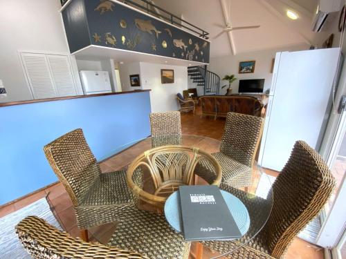 a dining room with chairs and a table with a laptop on it at Osprey Holiday Village Unit 119 in Exmouth