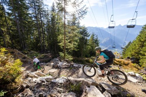 two people riding bikes on a rocky trail next to a ski lift at Haus Haas in Vandans