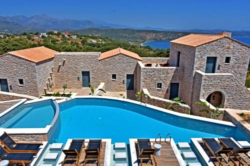 a villa with a swimming pool and a view at Opuntia Boutique Hotel in Kalívia