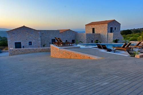 a patio with a swimming pool on top of a house at Opuntia Boutique Hotel in Kalívia