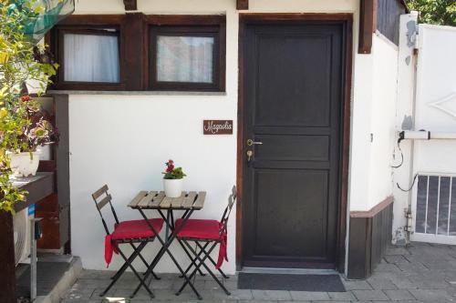 a black door with two chairs and a table at Casa Fiorita in Gragnano