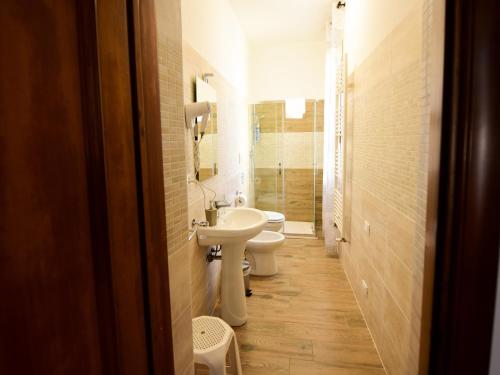 a bathroom with two toilets and a sink at Le Navi in Ortona
