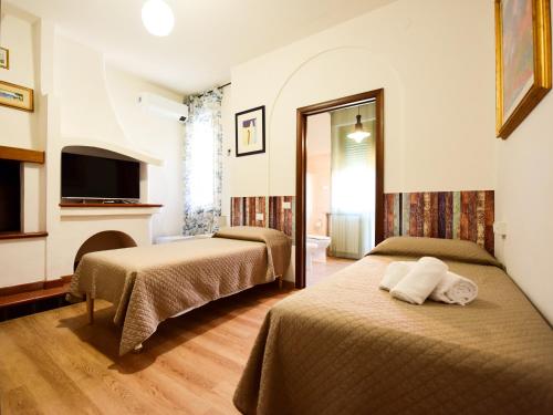 a hotel room with two beds and a fireplace at Le Navi in Ortona