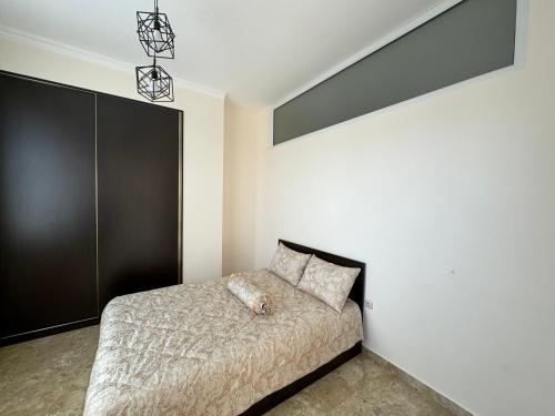 a bedroom with a bed and a black wall at SUPER Apartment in Yerevan in Yerevan