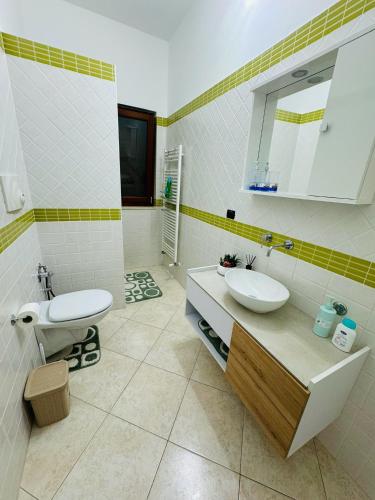 a bathroom with a sink and a toilet in it at Sole Luna Apartments in Monopoli