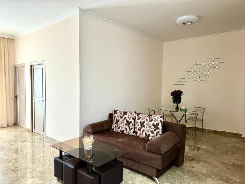 a living room with a couch and a table at SUPER Apartment in Yerevan in Yerevan