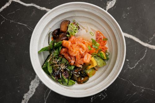 a white bowl filled with food on a table at Skostredet Hotel in Bergen
