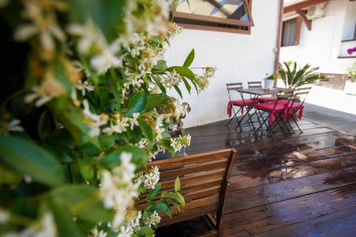a patio with a table and chairs and a wooden bench at Casa Fiorita in Gragnano