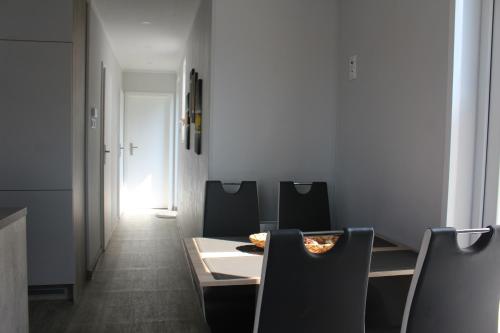 a dining room with a table and chairs at Ferienhaus Seeblick in Twist