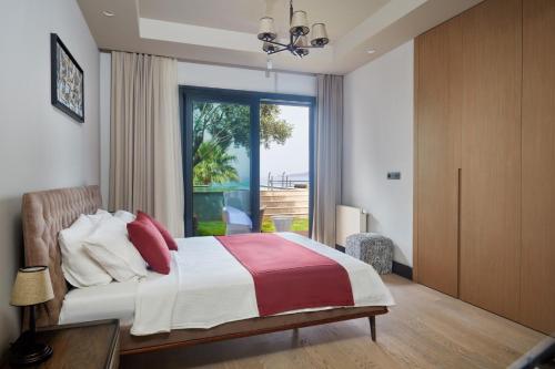 a bedroom with a bed and a large window at Root Redrock Yalıkavak in Yalıkavak