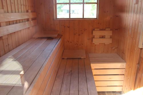 an inside of a sauna with benches and a window at Ferienhaus Seeblick in Twist