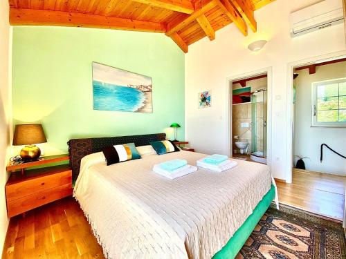 a bedroom with a large bed in a room at Villa Venus Privacy & Relax in Mošćenička Draga