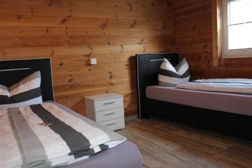 Postel nebo postele na pokoji v ubytování Ferienhaus Harmonie, Sauna,Seeblick, familienfreundlich