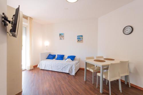 a bedroom with a bed and a table and a table and chairs at Residence Marconi Mare in Rimini