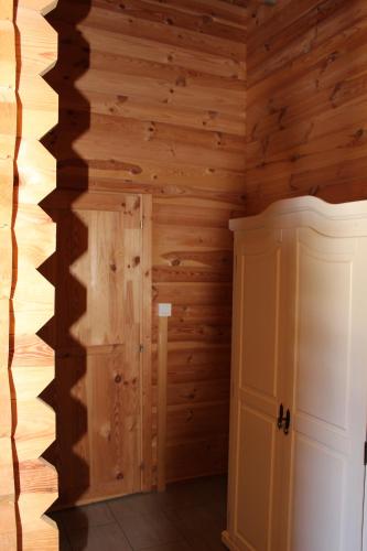 a room with wooden walls and a door at Ferienhaus Harmonie, Sauna,Seeblick, familienfreundlich in Twist