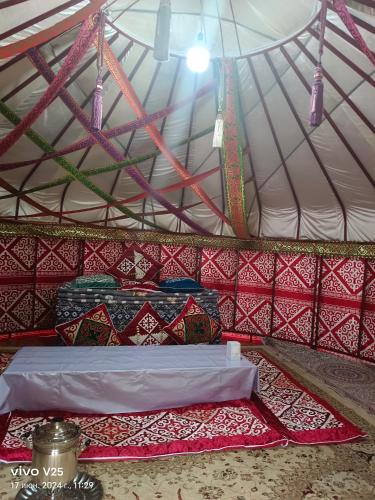 a room with a bed in a tent at Кольсайские озера, Юрта гостиницы Айару in Kurmenty