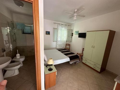 a small bedroom with a bed and a bathroom at Villa Monica appartamenti in Vieste