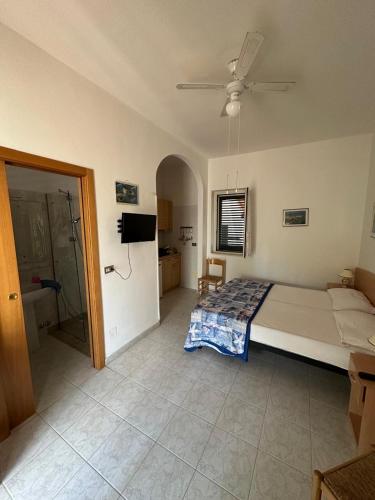 a bedroom with a large bed and a bathroom at Villa Monica appartamenti in Vieste