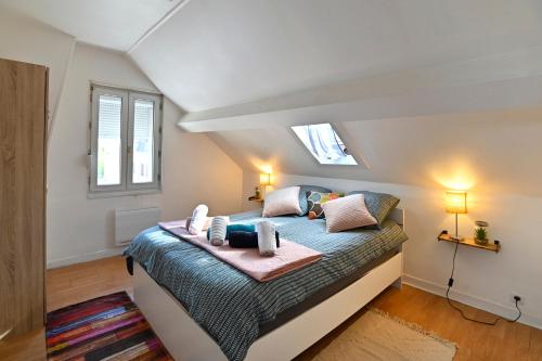 une chambre avec un lit dans un grenier dans l'établissement T2 Cosy et Lumineux - Proche centre et commodités, à Saint-Quentin