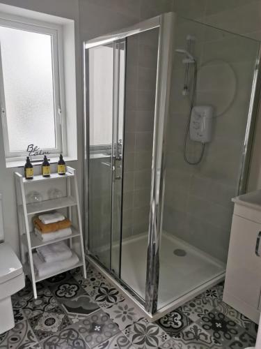 a bathroom with a shower and a sink at Hillside Lodge in Letterkenny