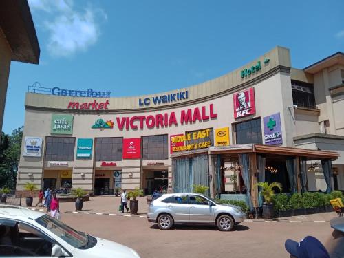 a mall with a car parked in front of it at Mowicribs Hotel and Spa in Entebbe