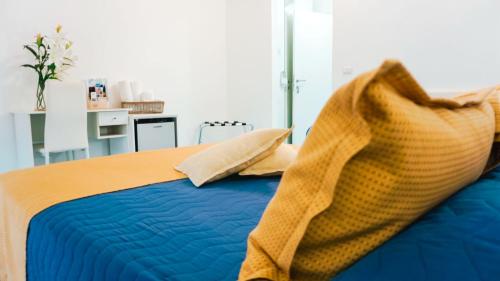 a bedroom with a blue bed with pillows on it at B&B A Casa di Vittoria - Guest House in Castellabate