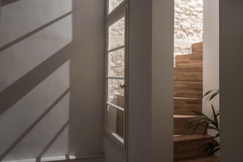 a door in a hallway with a window at Vegga Suites in Heraklio Town