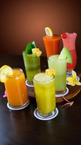 a group of different colored drinks on a table at Sapphire Sky Hotel & Conference in Serpong