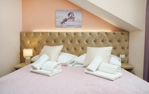 a bedroom with a large bed with white pillows at Hotel Stella Maris - Style & Comfort in Vodice