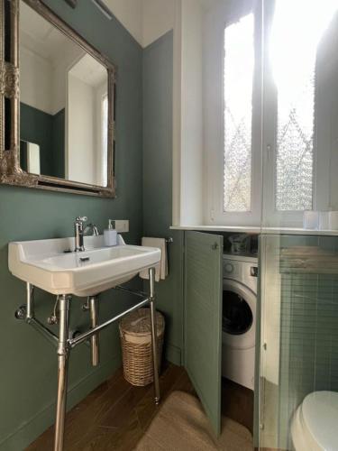 a bathroom with a sink and a washing machine at Camelia in Belgirate