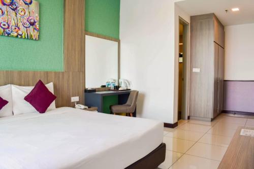 a hotel room with a bed and a desk at D'Wharf Hotel & Serviced Residence in Port Dickson