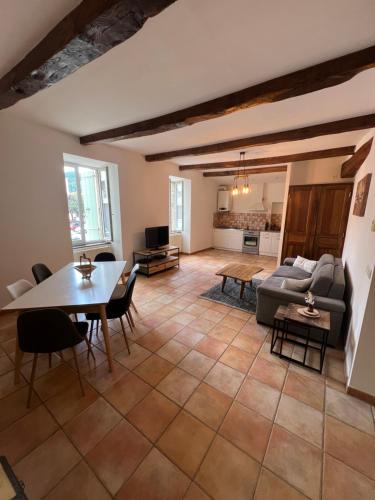 un salon avec une table et un canapé dans l'établissement Appartement et jardin vals les bains, à Vals-les-Bains