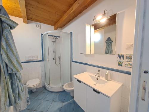a bathroom with a sink and a toilet and a shower at Magarà Apartment by Casa in mente in Cefalù