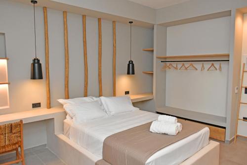 a bedroom with a large bed and a desk at Opuntia Boutique Hotel in Kalívia