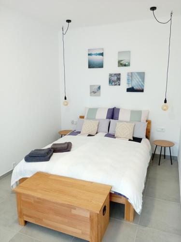 a bedroom with a large bed with a wooden table at Lind-Appartments in Villach