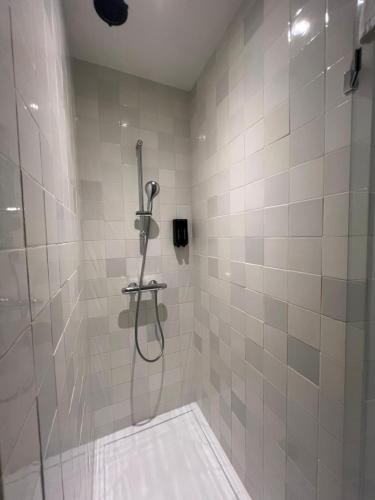 a bathroom with a shower with a shower head at Art Hotel Harlingen in Harlingen