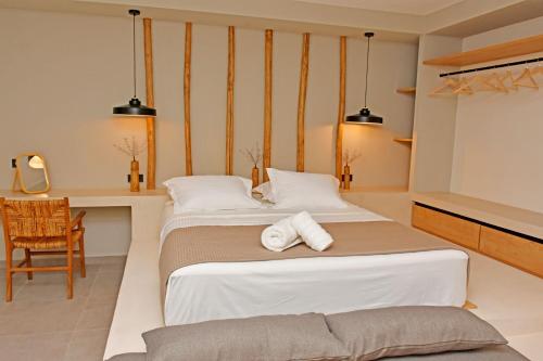 a hotel room with two beds and a desk at Opuntia Boutique Hotel in Kalívia