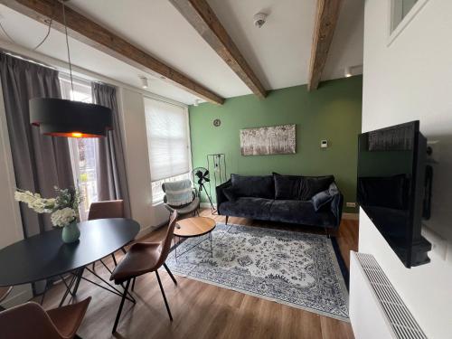 a living room with a couch and a table at Art Hotel Harlingen in Harlingen