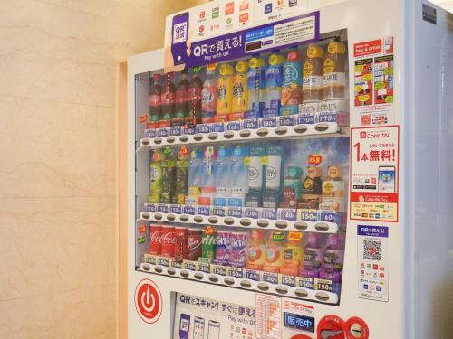 a refrigerator filled with lots of bottles of soda at The OneFive Osaka Namba Dotonbori in Osaka