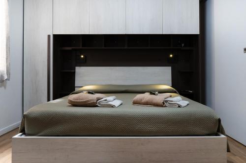 a bedroom with a bed with two towels on it at Il Loto in Bologna